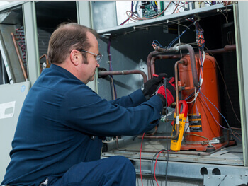 HVAC technician assessing an HVAC system